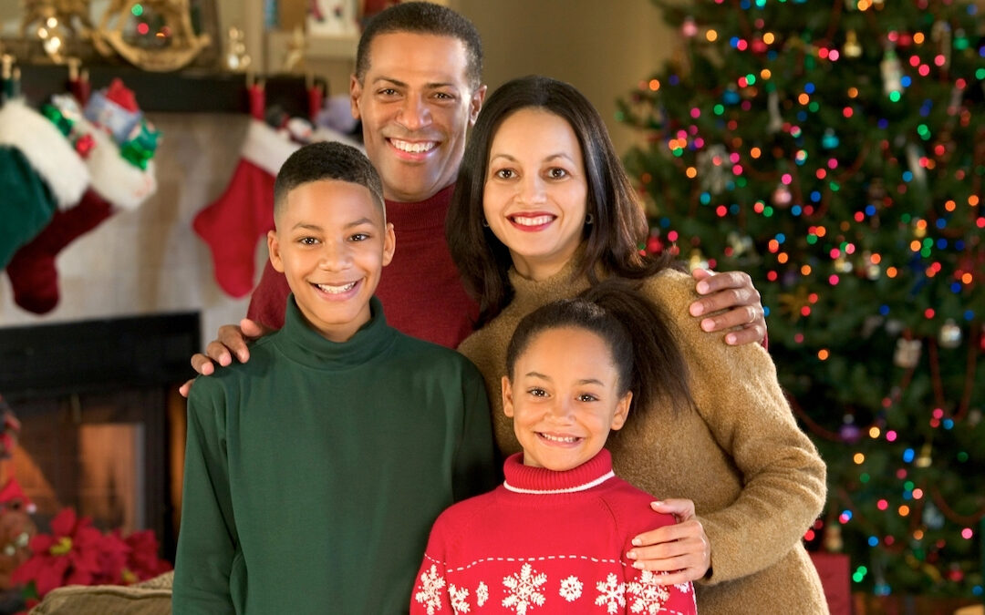 Christmas photo of a multicultural family with two kids.