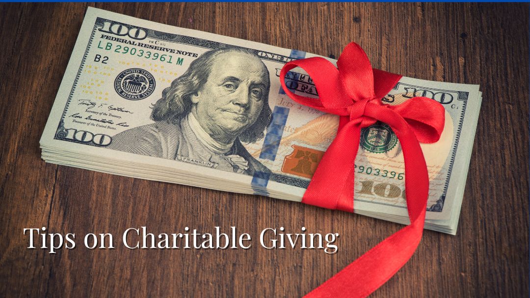 Red ribbon on a stack of money to illustrate Tips for Charitable Giving